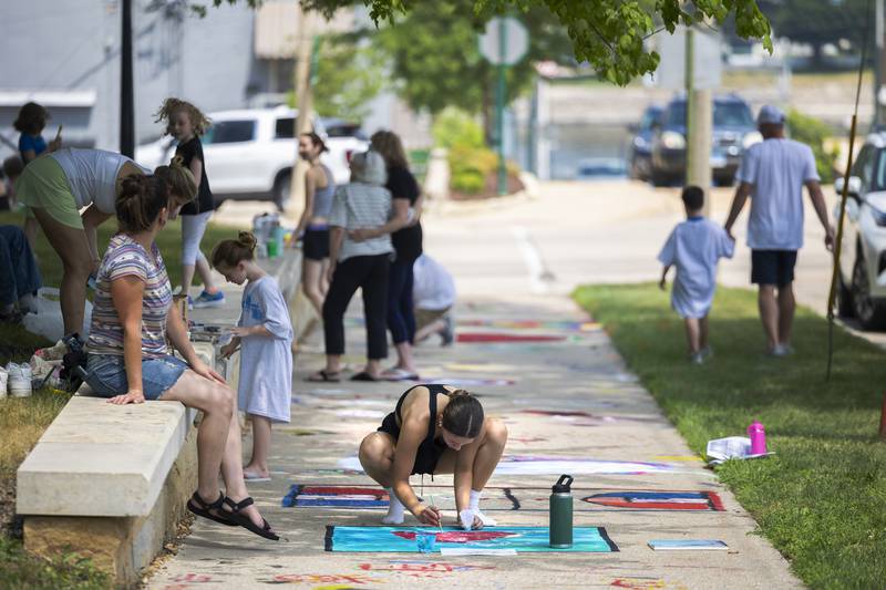Harvest Day puts the fine touches on her artistic expression Monday, July 3, 2023 during Petunia Fest’s Brush and Bloom.