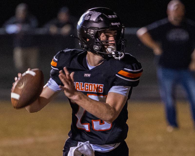 Brezdyn Simons (23) of FCW looks to throw football on Friday, Sept. 26, 2025 at Woodland High School in Streator.