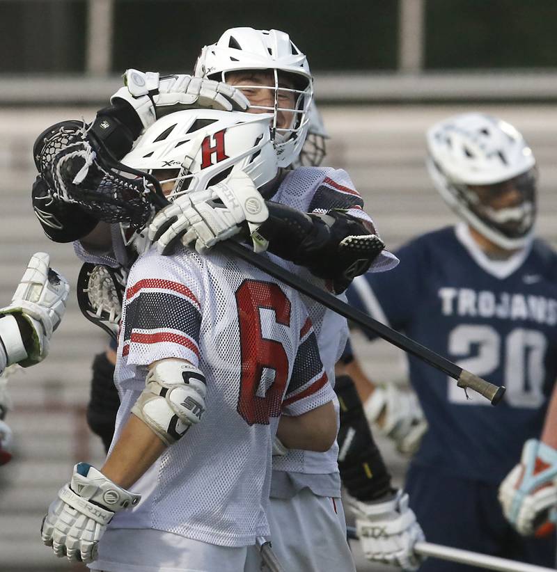 Huntley's Bobby Pupich hugs his teammate, Michael Boniak after Boniak scored a goal during the Marian Central Sectional boys lacrosse semifinal match against Cary-Grove on Wednesday, May 28, 2025, at Marian Central High School in Woodstock.