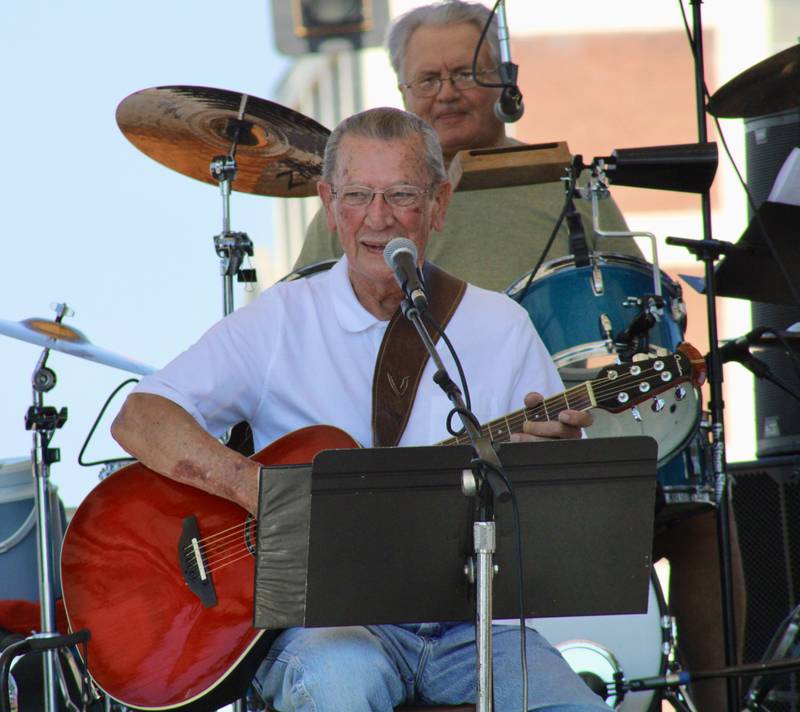 Lyle Grobe, seated in front of percussionist Dennis Milby, performs on Sunday from the Stella main stage at the Dixon Petunia Festival. The Dixon City Council proclaimed Sunday as Lyle Grobe day in recognition of his string of performances at 58 Petunia Festivals. In 1968, Grobe recorded the festival anthem "It''s Petunia Time in Dixon" and in 2009 was the grand marshal for the parade.