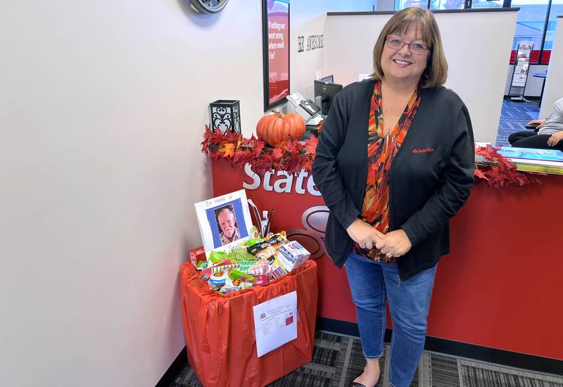 Sycamore-based State Farm agent Tina Hurst on Oct. 11, 2024 stands next to fill drop-box, and memorial to her uncle, a U.S. Army veteran of the Korean War. In October, she collaborated with Chicagoland Blue Star Mothers to send supplies to deployed members of the United States military.