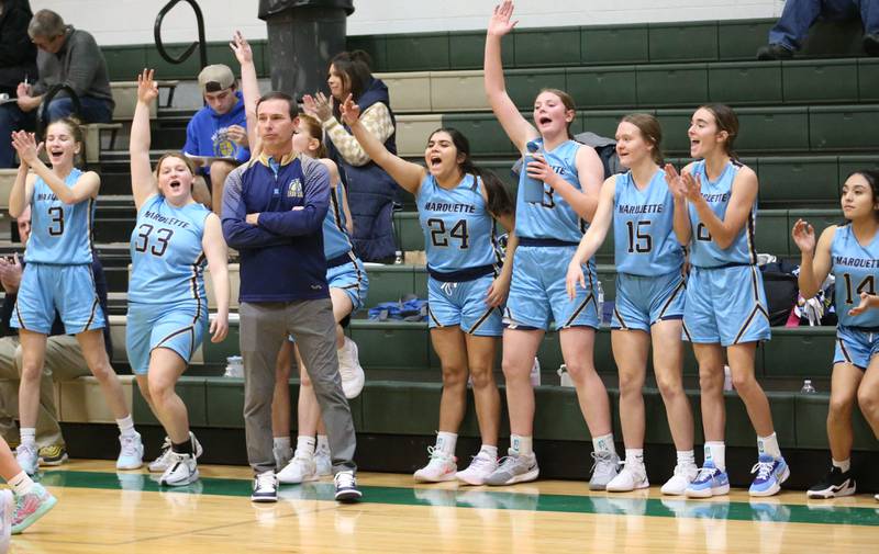 Members of the Marquette girls basketball team react after making a shot against St. Bede on Monday, Dec. 2, 2024 at St. Bede Academy.