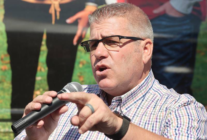 Darren Bailey, a Republican candidate for Illinois governor, speaks in front of his bus Friday, June 17, 2022, during his campaign stop at Tom and Jerry's in Sycamore. Bailey is currently on a bus tour across the state that will cover 102 countys in 14 days.