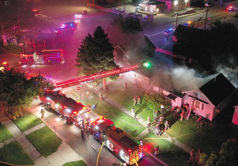 Firefighters work the scene of a structure fire in the 100 block of West Cleveland Street on Thursday, May 15, 2025 in Spring Valley. The fire broke out shortly before 8:30p.m. Fire departments from La Salle Bureau and Putnam Counties responded to the scene. A mutual aid box alarm system (MABAS) call was issued prompting the response.