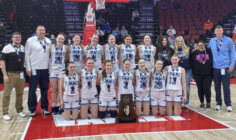Members of the Cissna Park girls basketball team pose with the Class 1A third place trophy on Friday, March 7, 2025 at CEFCU Arena in Normal.