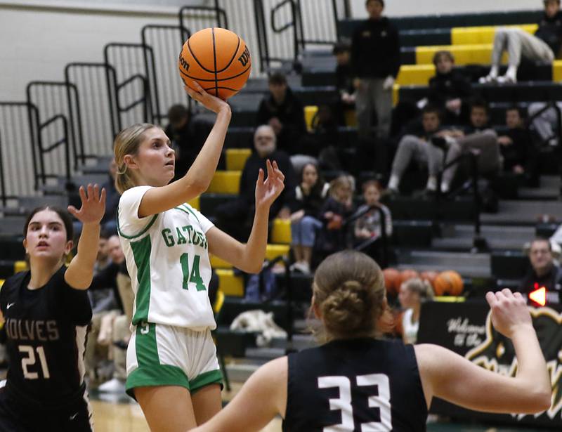 Crystal Lake South's Makena Cleary shoots the ball between Prairie Ridge's Maia Cassin (left) and Emily McPherson (right) during a Fox Valley Conference girls basketball game on Friday, Dec. 13, 2024, at Crystal Lake South High School.