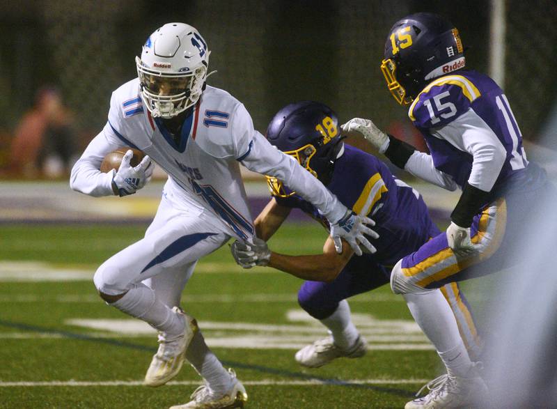 Lakes' Tyson Dewey (11) returns a Wauconda kick during Friday’s football game in Wauconda.