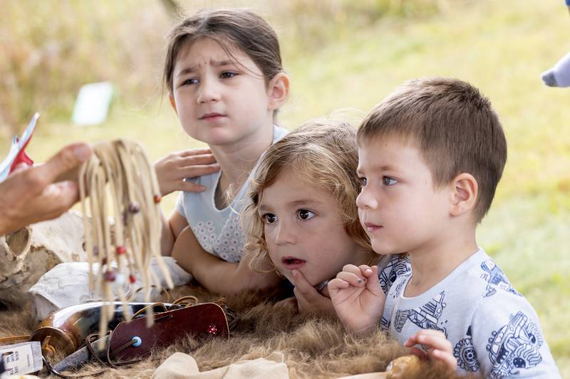 Saylor (left), Atlas, 3, and Apollo Hey, 3, all of Dixon, learn about Bison at Nachusa’s Autumn on the Prairie Saturday, Sept. 20, 2025.