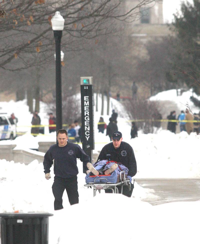 Shaw Local 2008 file photo – Paramedics rush a victim to a waiting ambulance following a shooting Thursday, Feb. 14, 2008 at Northern Illinois University in DeKalb. Altgeld Hall is in the background.