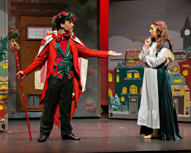 The Spirit of Christmas Present (Derrick Wilson) visits Elizabeth Scrooge (Nicole Lapas) in a new retelling of Charles Dickens' "A Christmas Carol." It's a Theatre 121 production in Woodstock