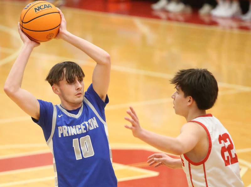 Princeton's Gavin Lanham looks to pass the ball around Ottawa's Dom Parks on Monday, Feb. 3, 2025 in Kingman Gymnasium at Ottawa High School.