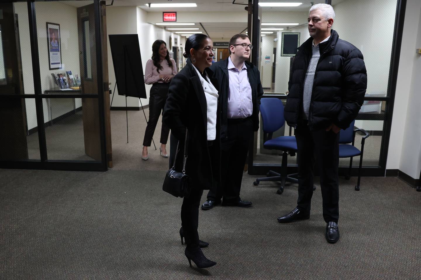 Democrat candidate for Will County Judge Jessica Colon-Sayre, front center, waits as mail in ballots are counted on Tuesday at the Will County Office Building.