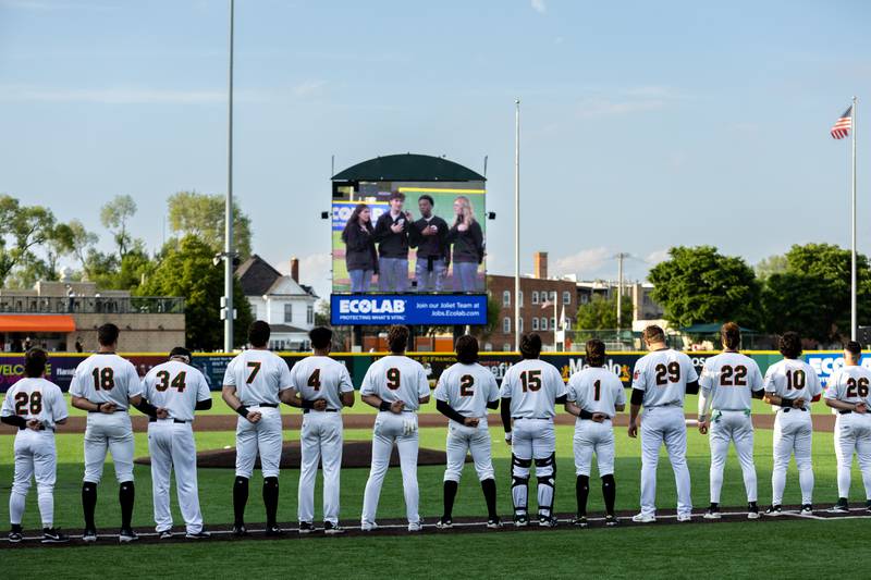 Members of the Joliet Slammers stand as ‘The National Anthem’ is performed during the home opener on Friday, May 8, 2026.