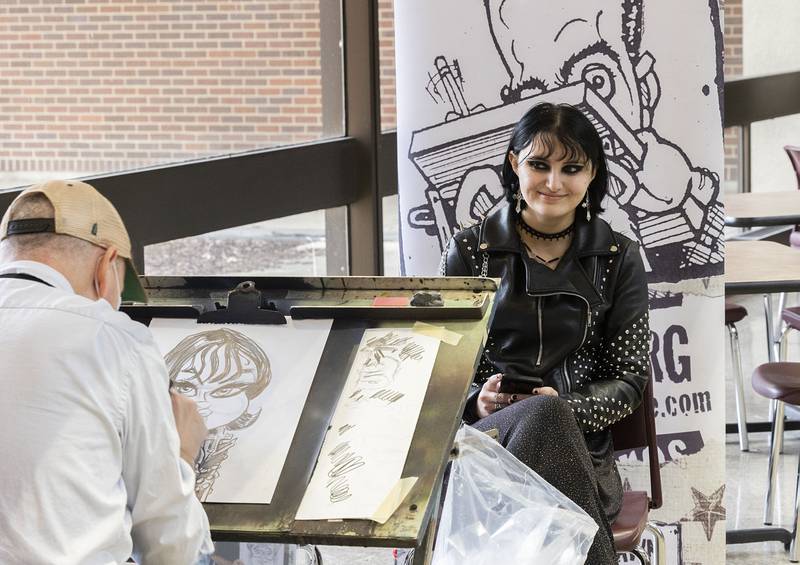 Amelia Mount of Sterling has her caricature drawn by artist Kevin Berg Tuesday at Sauk Valley College. Tuesday marked the first day of classes for students in the spring semester. The Student Activities and Student Government Association wanted to welcome students back with the fun event.