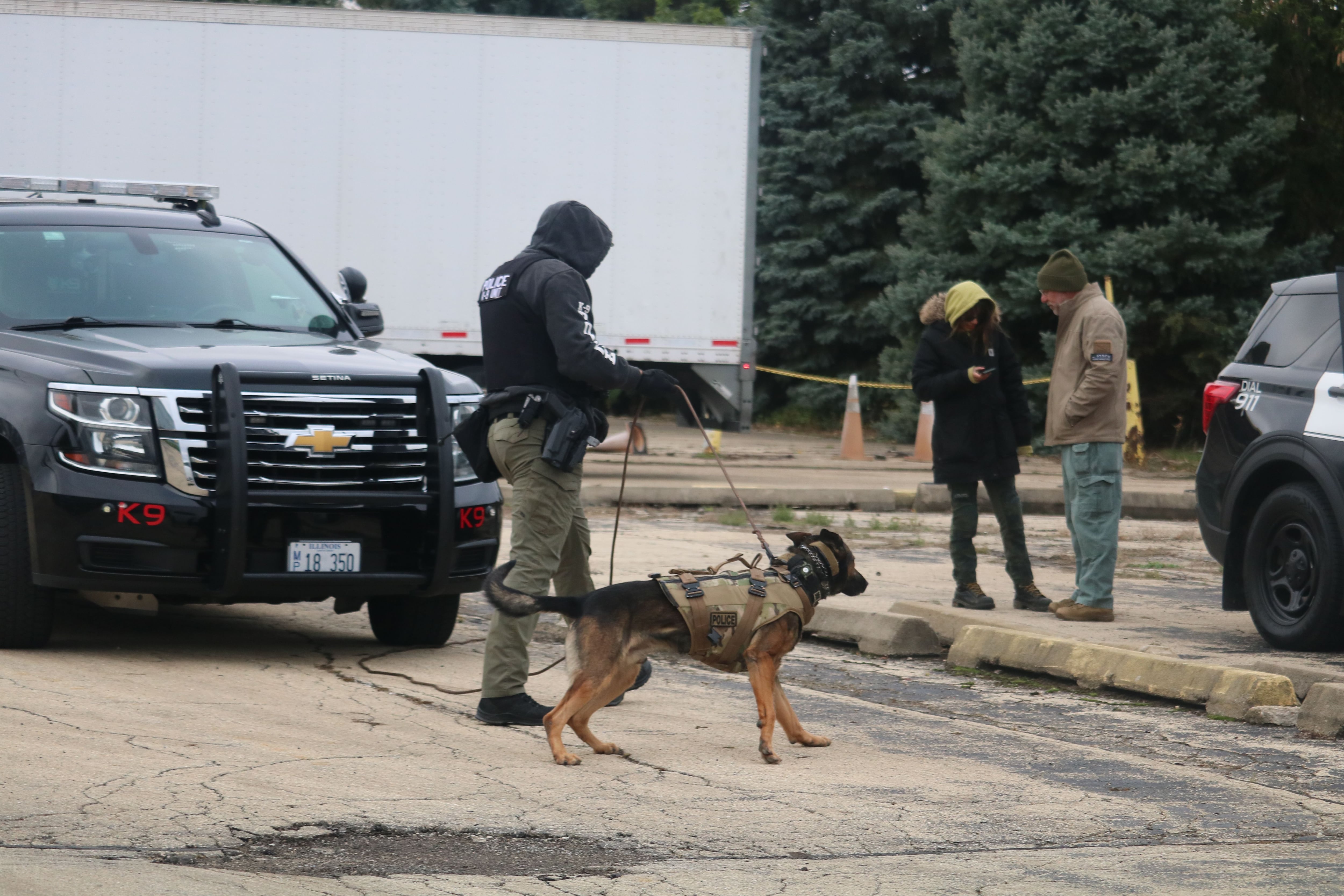 DeKalb police Sgt. Steve Parsons (left) is seen with Chase Oct. 22, 2025, preparing for a training sequence outside the former GE plant in DeKalb.