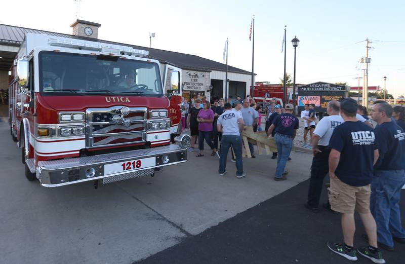 Utica firefighters, and the community gather around a new Pierce Heavy Duty Rescue Truck at the Utica Fire Station on Thursday, Sept. 14, 2023. The $706,000.00 truck will replace a 28 year old rescue truck. The new vehicle will have equipment to handle water rescue, industrial accidents and grain bin emergencies. The department hopes to have it in operation on Columbus Day weekend.