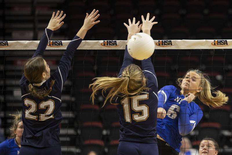 Newman’s Jess Johns lets loose a hard hit against Aquin’s Meghan Carlisle (left) and Megan Holder Friday, Nov. 11, 2022 in a class 1A volleyball semifinal.