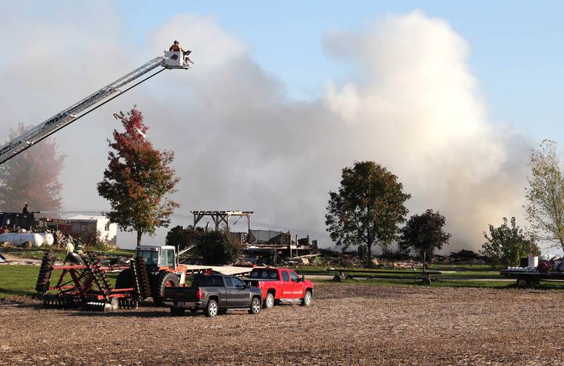 Several area fire departments put water on the smoldering remnants of a house Tuesday, Oct. 17, 2023, after an explosion at the residence on Goble Road in Earlville.