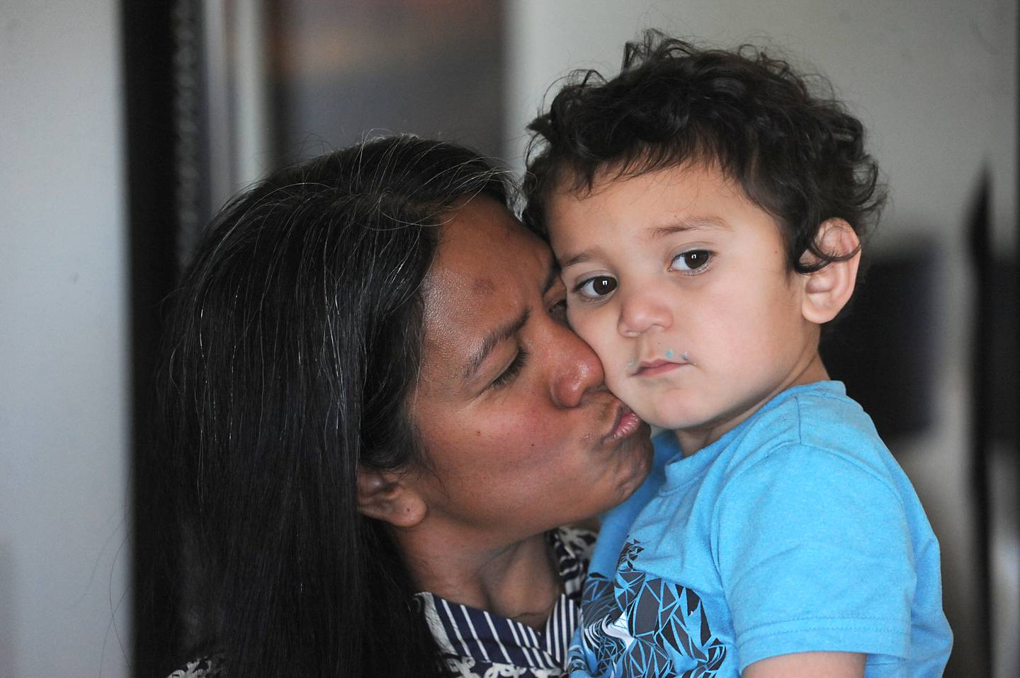 Wilma Alex kisses her son, Brian, as she talks about all the help she received after being nearly killed in early March, during an interview Thursday, April 21, 2022, in her apartment in McHenry County. Her husband, Mark Alex, was charged with attempted first-degree murder.