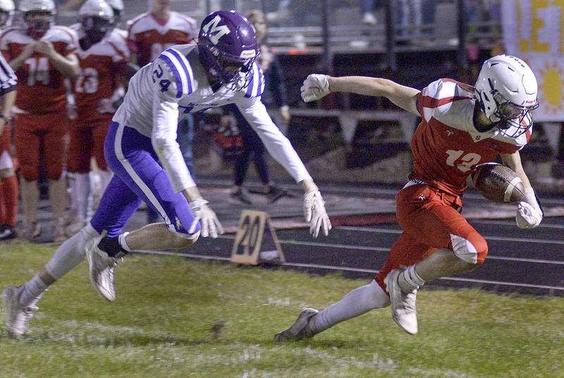 Streator’s Anthony Mohr works to get past Manteno’s Nathan Hope on a run in the 1st quarter Friday at Streator.
