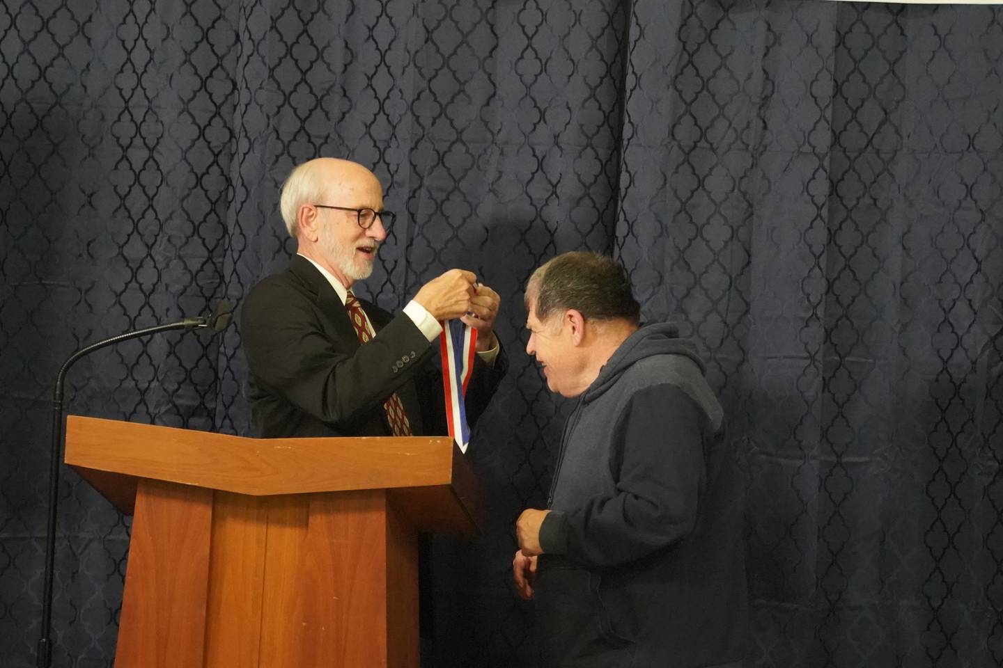Tim Koebler received the Coach Cookie Warren Memorial Award at the Village of Progress Annual Banquet on Wednesday, Oct. 22, 2025 in Oregon. At left is Master of Ceremonies Tom Wadsworth.