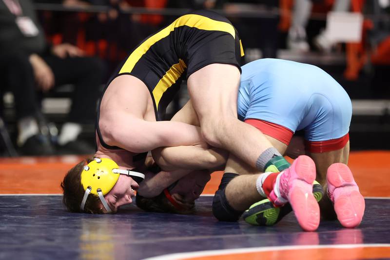 Riverdale’s Brock Smith works over Marian Central’s Vance Williams in the Class 1A 132lb. semifinals at State Farm Center in Champaign. Friday, Feb. 18, 2022, in Champaign.