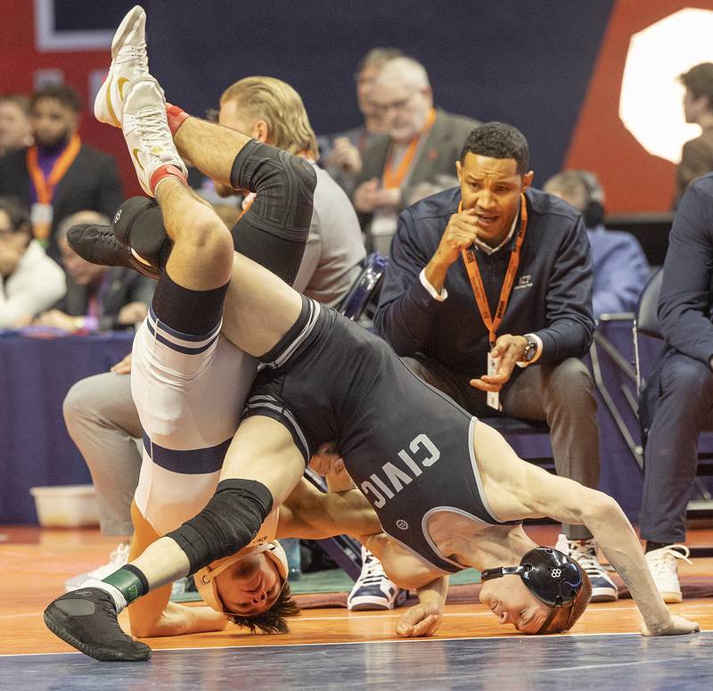 IC Catholic’s Deven Casey (left) and Civic Memorial’s Bradley Ruckman compete in the 132 pound weight class of the 2A state individual wrestling finals Saturday, Feb. 22, 2025, at State Farm Center in Champaign.