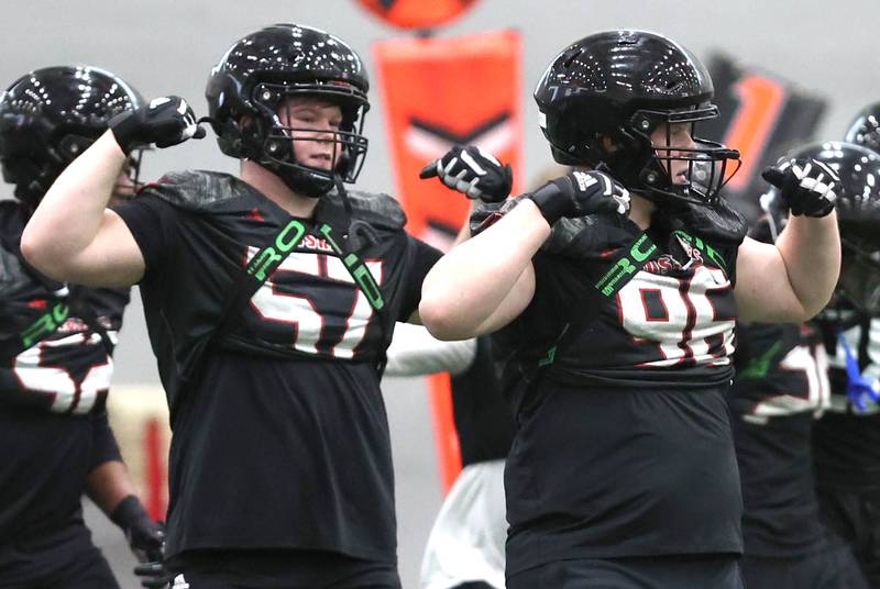 Members of the Northern Illinois University defense react after a good play Tuesday, March 26, 2024, during spring practice in the Chessick Practice Center at NIU in Dekalb.