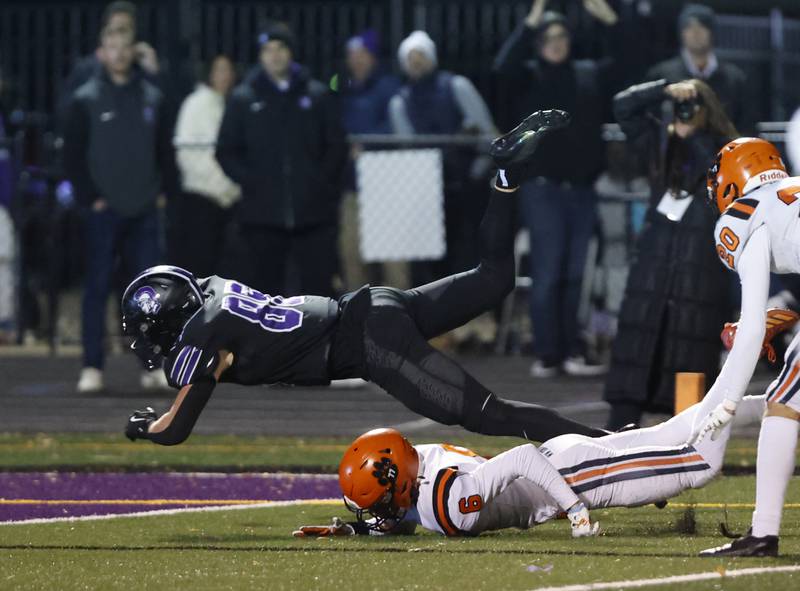 Downers Grove North's Will Vala (85) dives across the goal line for a touchdown during the 7A first-round playoff game between Wheaton Warrenville South and Downers Grove North high schools on Friday, Nov. 1, 2024 in Downers Grove.