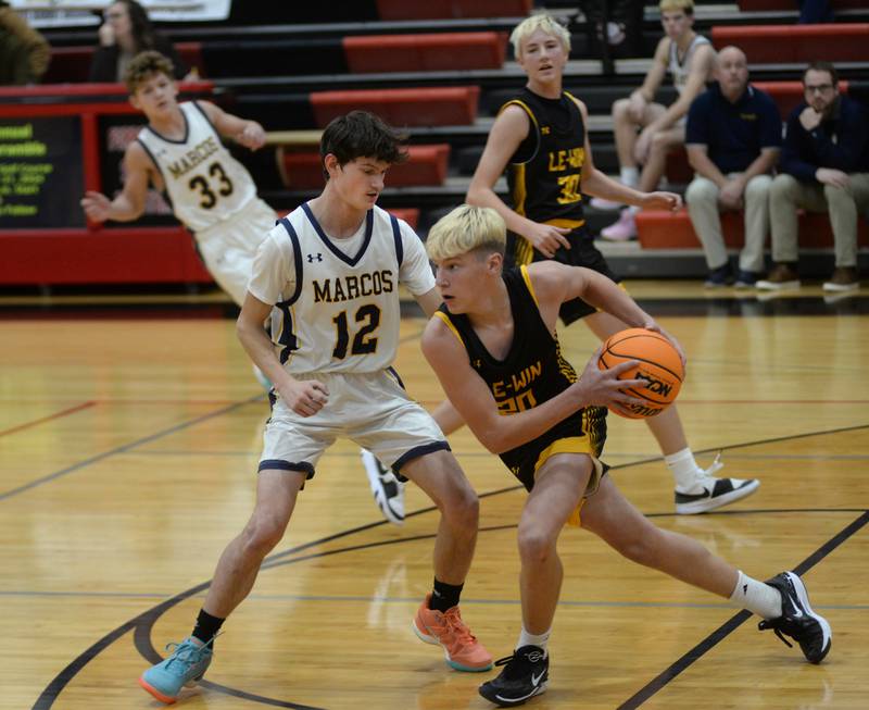 Polo's Bill Lowry (12) guards Lena-Winslow's Cooper Gilbertson (20) on Wednesday, Dec. 18, 2024 at the 63rd Annual Forreston Holiday Tournament.