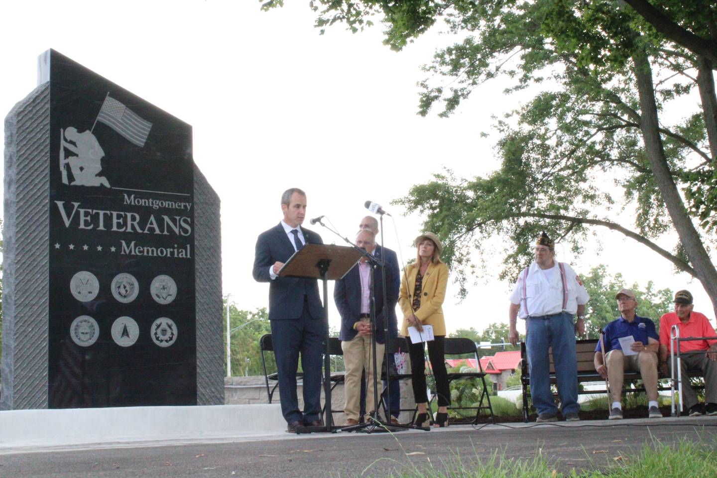 Montgomery Village President Matt Brolley speaks before the newly unveiled veterans monument in Montgomery