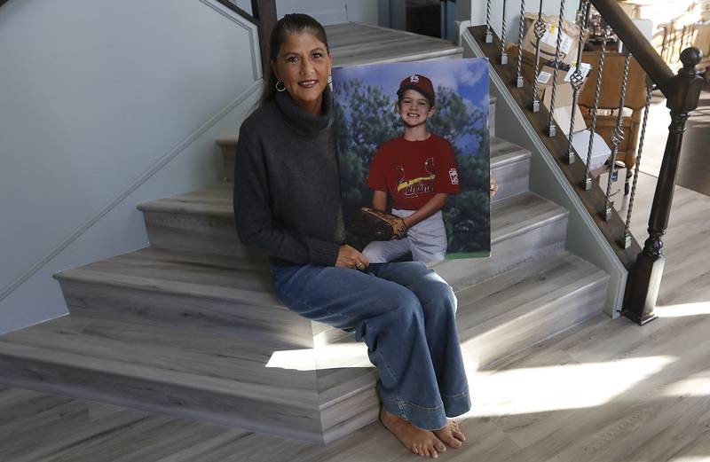 Margaret Borcia, holds a photograph of her son, Tony. who was killed by an intoxicated boater in 2012, on the Chain of Lakes . She now works in McHenry County courthouse and other courthouses as a victim advocate for AAIM.