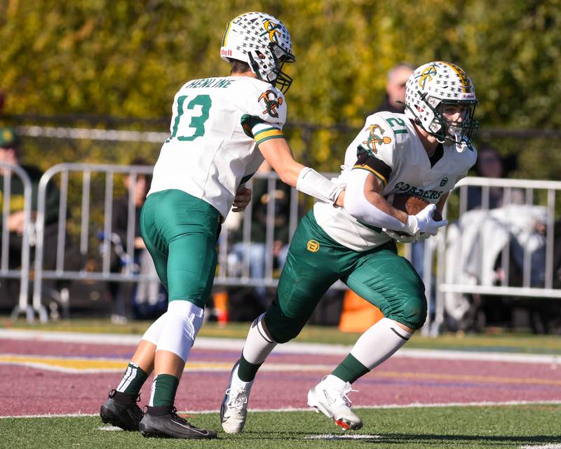Coal City's Connor Henline (13) hands the ball to teammate Coal City's Logan Natyshok (21) during the 4A quarterfinals game on Saturday Nov. 15, 2025, held at Montini Catholic High School.
