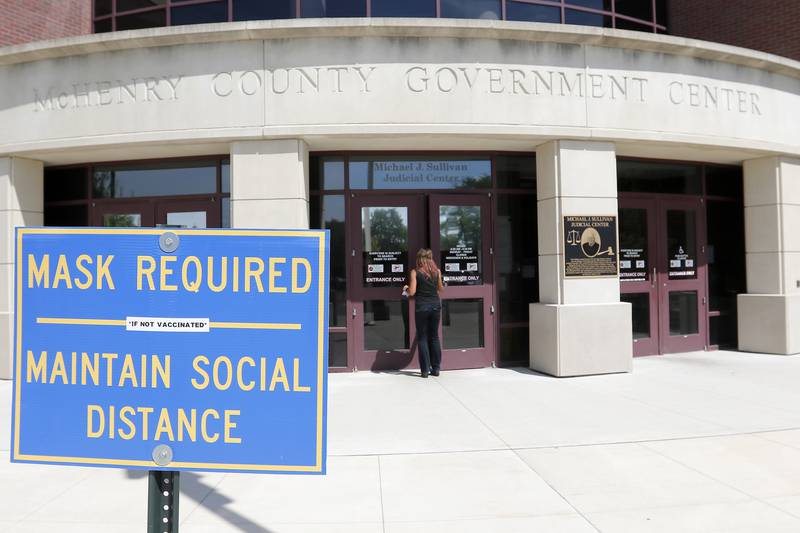 A woman walks into the Michael J. Sullivan Judicial Center on Thursday, Aug. 26, 2021, in Woodstock.