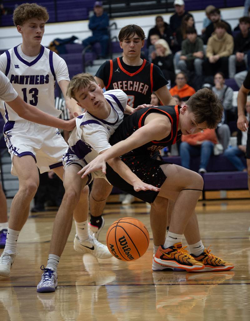 Beecher's Gavin Van Ness, right, and Manteno's Eric Eldridge, left, try to contain a loose ball in the Thanksgiving tournament at Manteno High School on Monday, November 24, 2025.