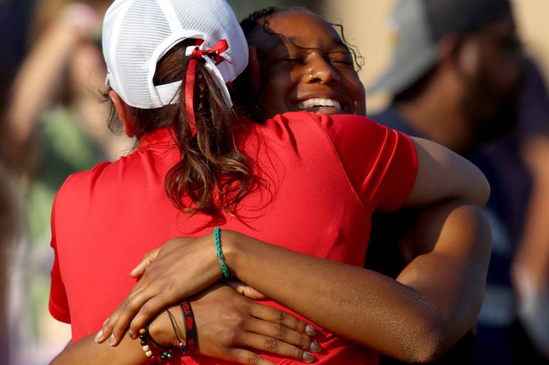 Huntley’s Dominique Johnson is greeted by coach Jennifer Garza after competing in the long  jump in IHSA Class 3A Girls Sectional Track and Field Meet action at Red Raider Stadium on the campus of Huntley High School in Huntley on Wednesday, May 14, 2025.