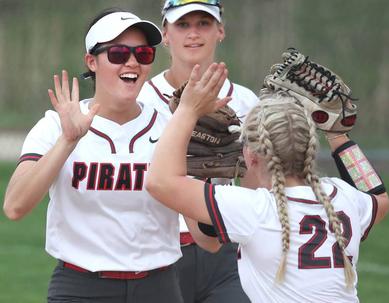 Ottawa’s Zulee Moreland (left) is congratulated after a big catch by teammate Reese Purcell during their game against Sycamore Thursday, May 2, 2024, at Sycamore High School.