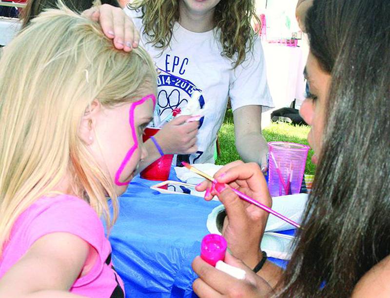 Nikki Sweitzer of Lanark gets a butterfly, artistically face-painted by EPC Cheerleader Anastasia Matias.