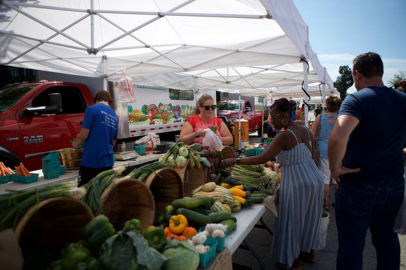 Market goers visit the Wheaton French Market on Saturday Sept. 3, 2022 in Wheaton.