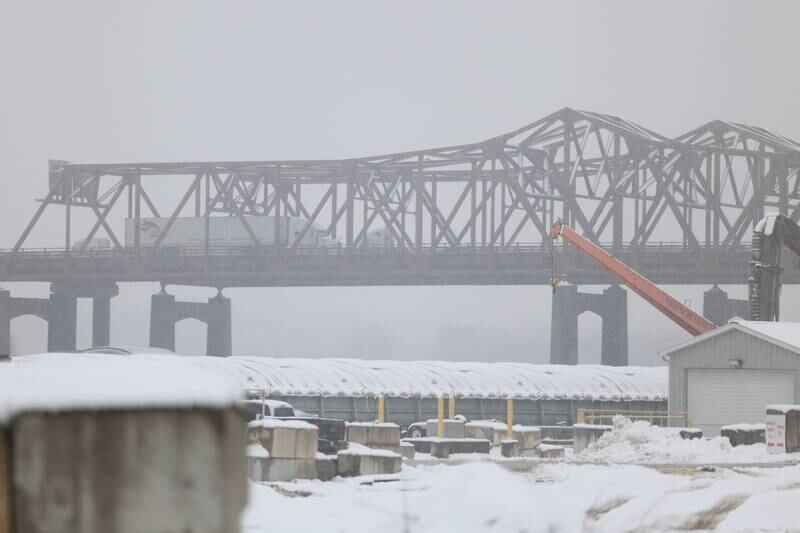 Snow falls as traffic moves along the I-80 Des Plaines River Bridge in Joliet on Wednesday January 25th, 2023.