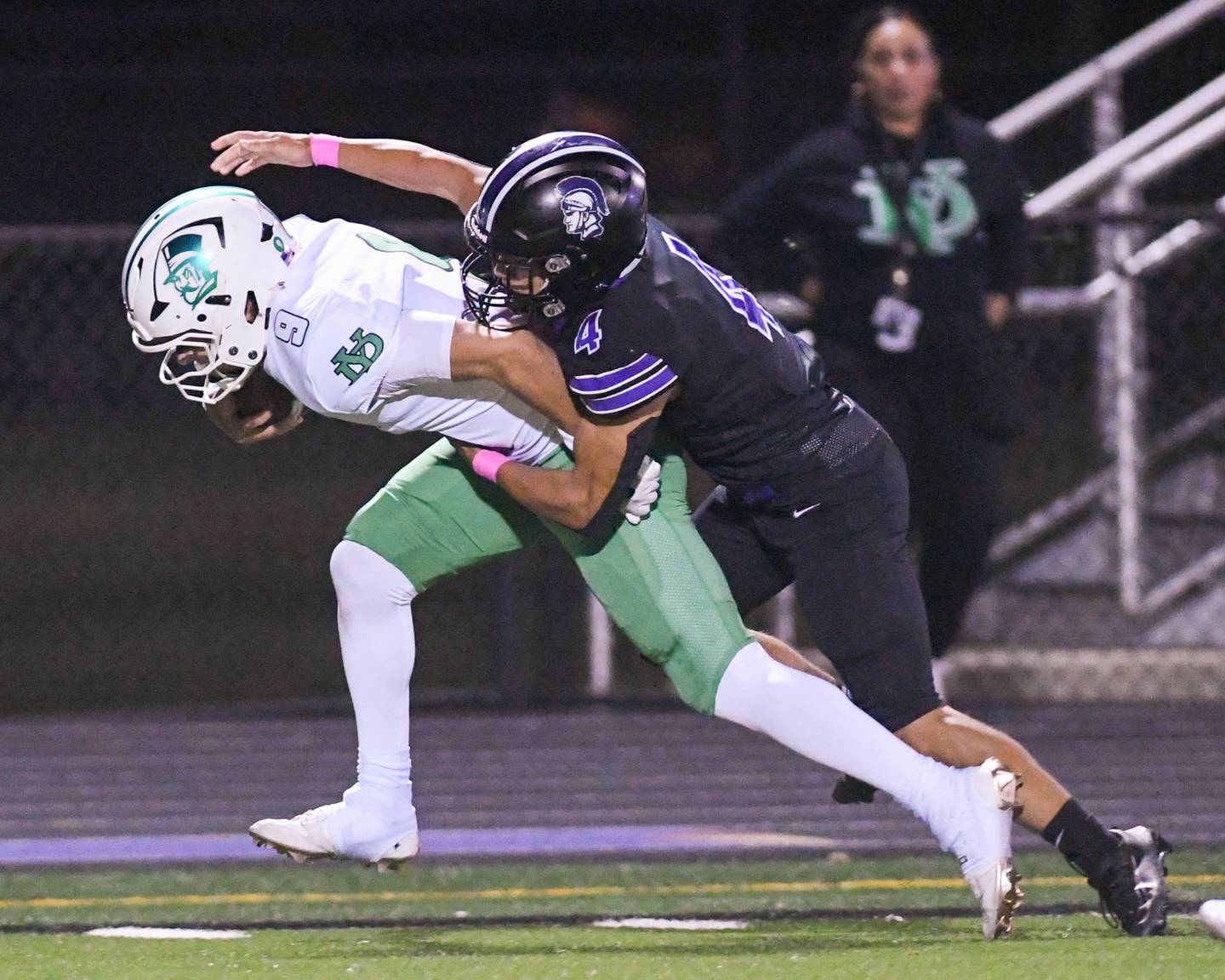 York's Dominic Alfano (9) carries the ball while getting a first down before being brought down by Downers Grove North's Caden Chiarelli (4) during the game on Friday Oct. 10, 2025, held at Downers Grove North High School.