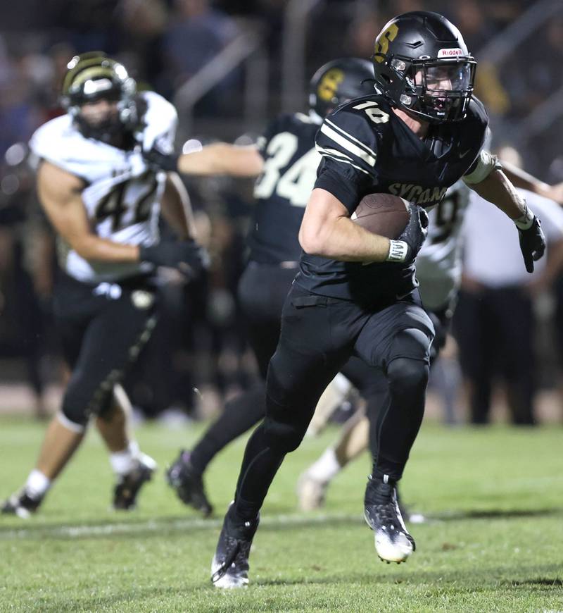 Sycamore's Zack Crawford gets outside the Oak Forest defense for a nice gain during their game Friday Sept. 2, 2022, at Sycamore High School.