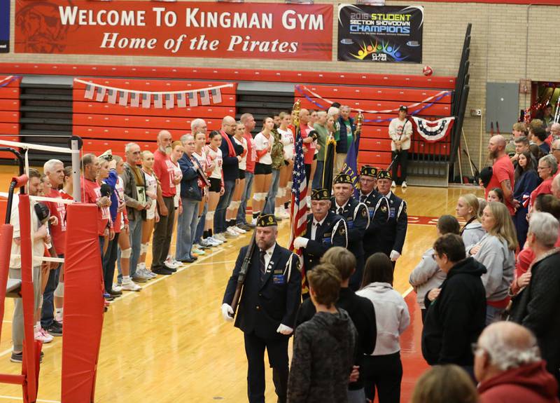 Ottawa and L-P volleyball players stand with Veteran family members and friends as Ottawa American Legion Post 33  Veterans present the Colors during the "Volley for Vets" night on Thursday, Oct. 17, 2024 in Kingman Gym at Ottawa High School.