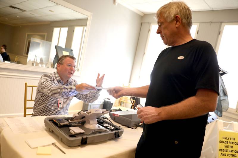 Election Judge Chris Potts (left) helps Batavia resident Al Runde at the Lincoln Inn and Banquets polling place in Batavia for the General Election on Tuesday, Nov. 8, 2022.