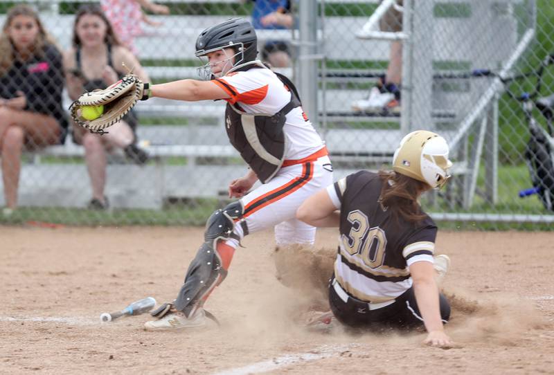 Sycamore's Brooklynn Snodgrass slides into home as DeKalb's Maddie Hallaron catches the throw during a play at the plate during their game against Sycamore Friday, May 20, 2022, at Sycamore High School.