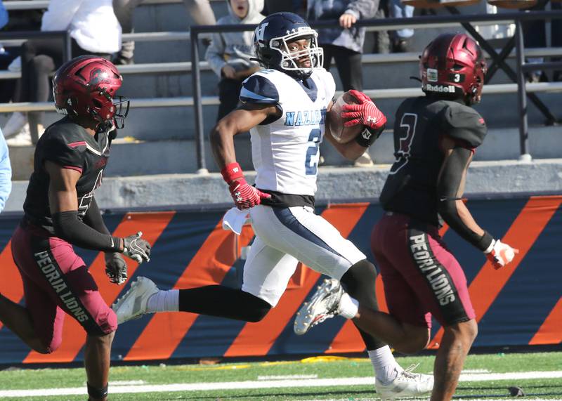 Nazareth's Justin Taylor races past the Peoria defense during their IHSA Class 5A state championship game Saturday, Nov. 26, 2022, in Memorial Stadium at the University of Illinois in Champaign.