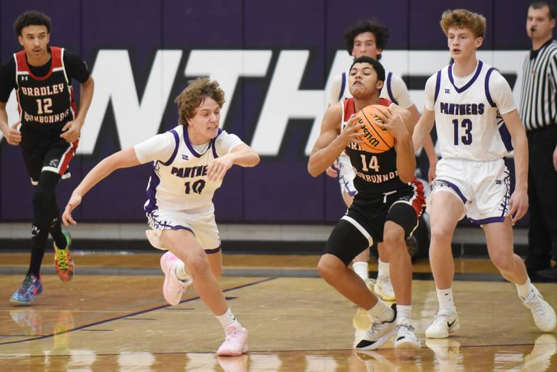 Bradley-Bourbonnais' Jayden Stewart (14) beats Manteno's Jack Gotkowski to a loose ball during a game at Manteno Saturday, Dec. 6, 2025.
