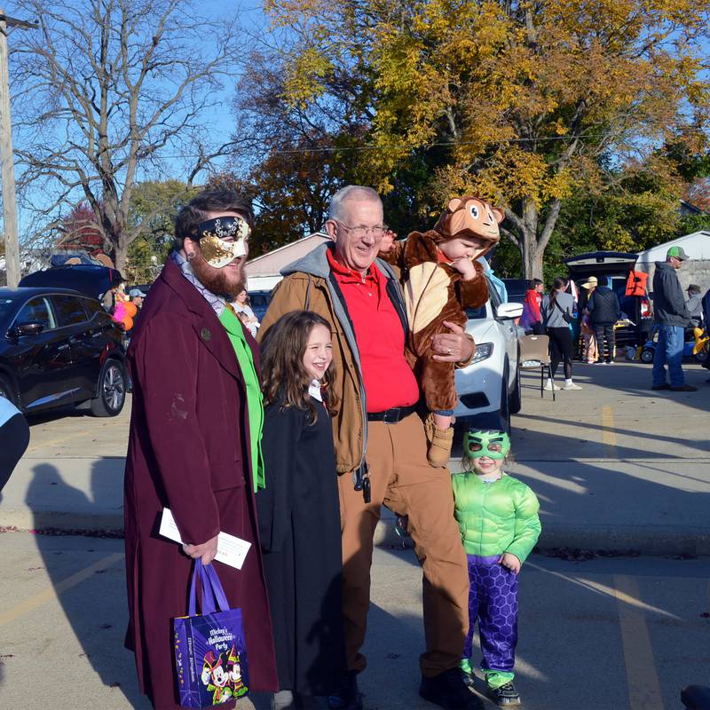 A family poses for a photo on Saturday, Oct. 26, 2024, while attending a trunk-or-treat at Crossroads Community Church's Polo campus. Left to right are Travis Fisher, of Dixon, dressed as a phantom; Shiloh Haas, 9, dressed as Hermione Granger; David Dahl, of Polo, as himself; Asher Full, 1, dressed as a monkey; and Theo Fisher, 4, dressed as Hulk.