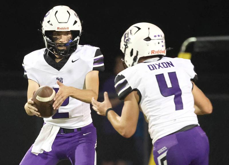 Dixon's Cullen Shaner flips the ball to Landon Knigge during their game Friday, Sept. 20, 2024, at Genoa-Kingston High School.