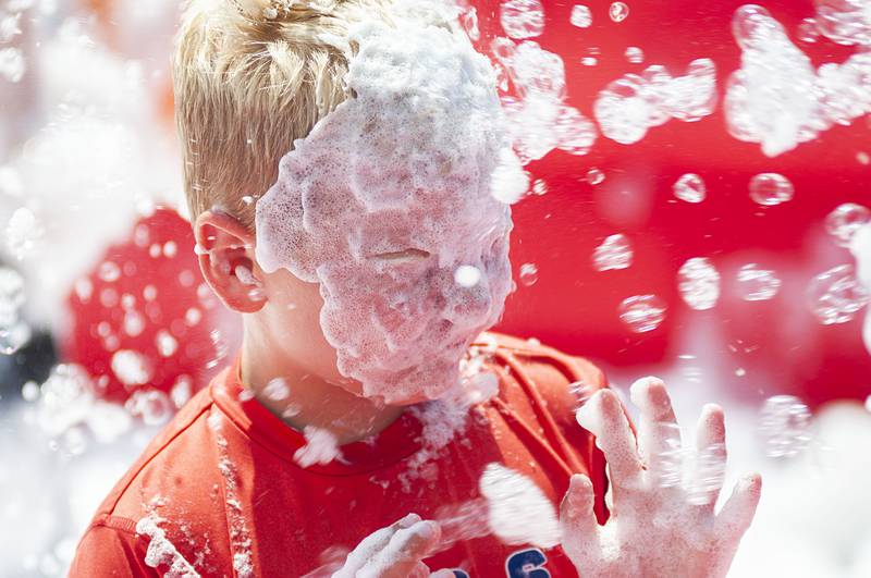 Drew Houzenga, 6, of Morrison gets a face full of suds Saturday, July 30, 2022 at Morrison’s first ever Shuckfest. The first time festival featured music, food, vendors and fun and games for the kids.